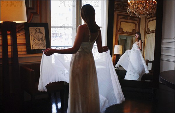 05/00/2003. EXCLUSIVE Clotilde Courau tries gowns on at Valentino's before the 56th Cannes Film