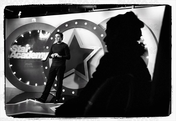 12/00/2003. Nikos Aliagas, host of the Star Academy shows backstage and on stage.