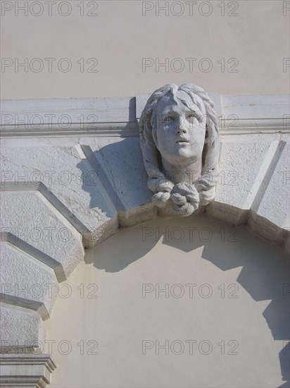 Sculpted head on a facade in the district of Dorsoduro in Venice