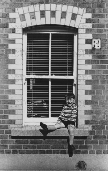 Boy in window, Ringsend, Dublin