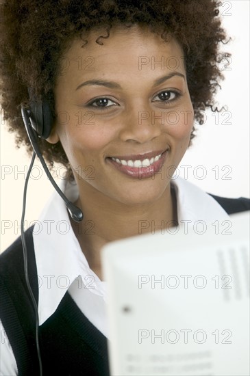 Woman wearing telephone headset.