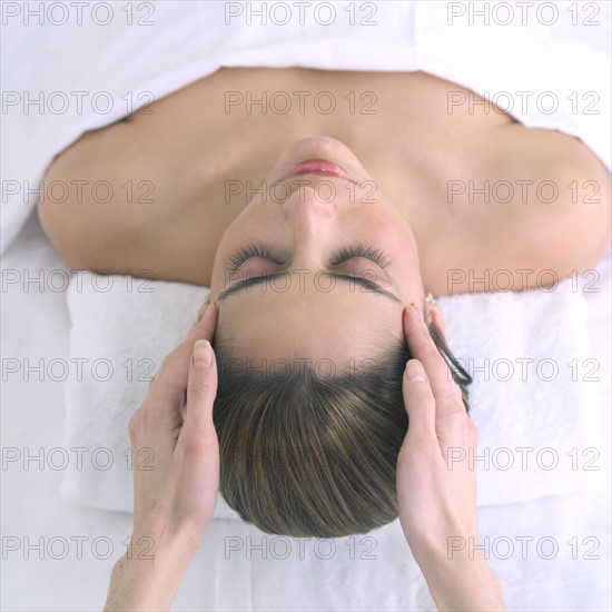 Woman receiving a head massage.
