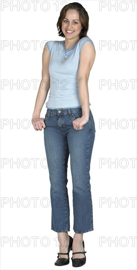 Woman with her thumbs in her pockets.