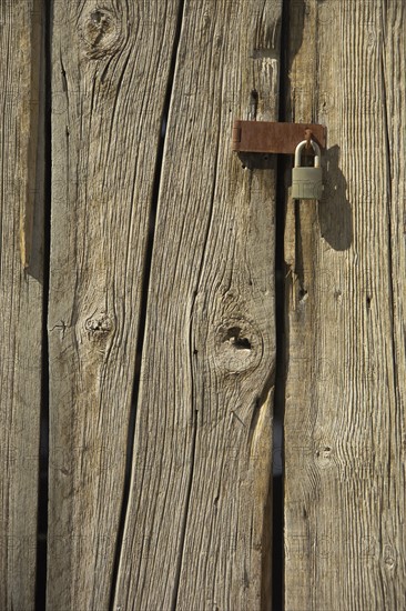 Padlock on a barn door.