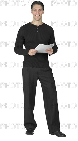 A young man holding documents.