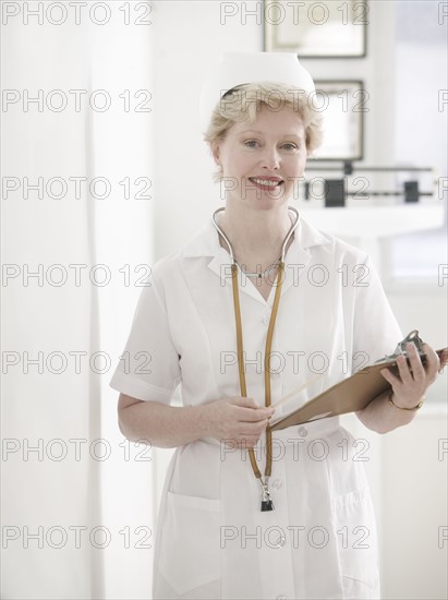 Female nurse with clipboard.