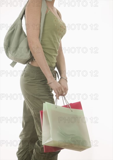 Female torso carrying bags.