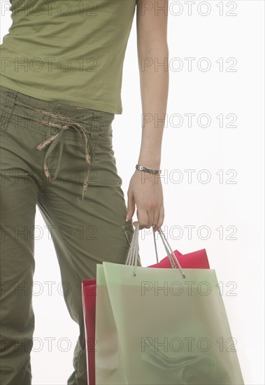 Female arm holding shopping bags.