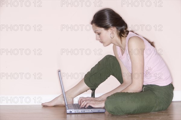 Woman sitting with laptop computer.