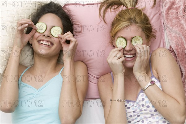 Girls with cucumbers on eyes.