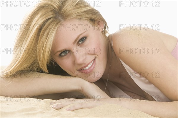 Headshot of blond woman prone.