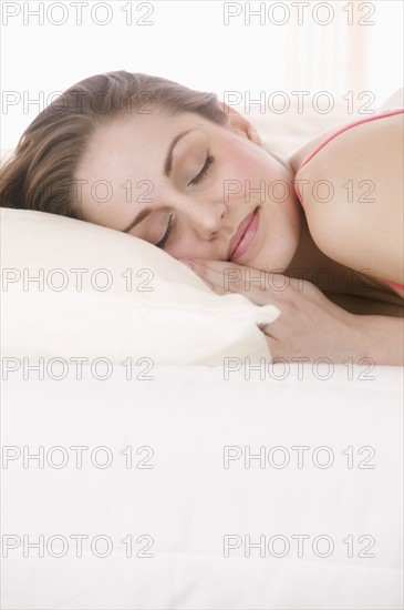 Closeup of smiling woman sleeping.