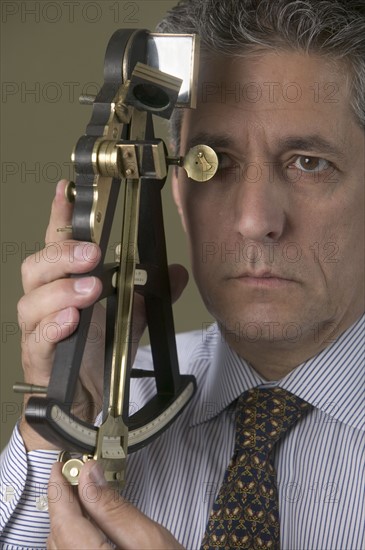 Man holding octant.