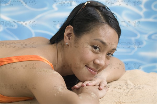 Woman reclining in swimsuit.