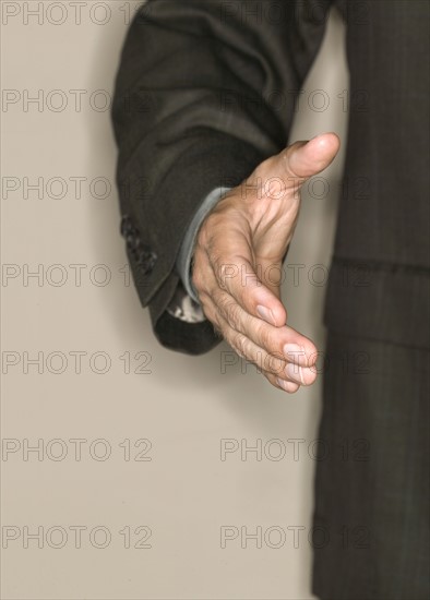 Man reaching out to shake hands.