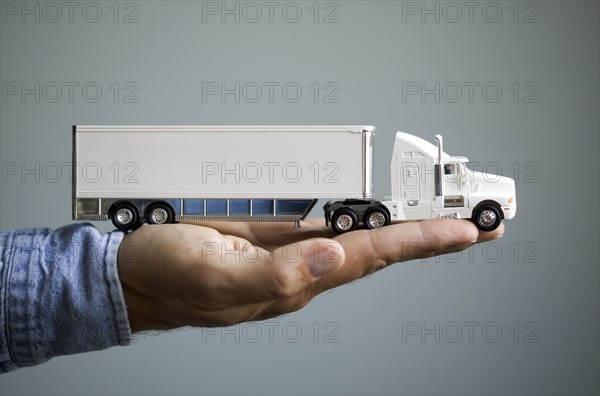Close up of man's hand holding toy truck.