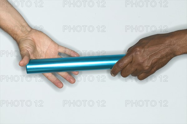 Passing baton from one hand to another.