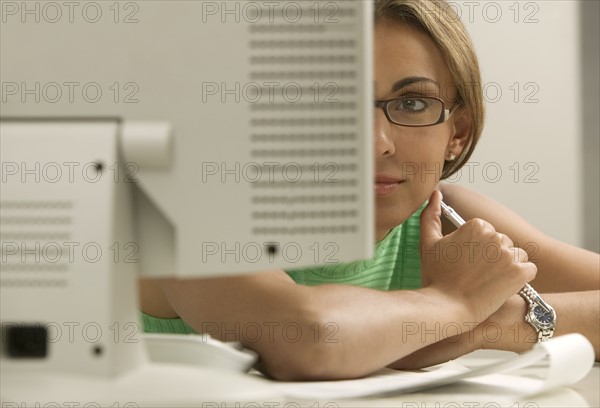 Woman looking at computer monitor.