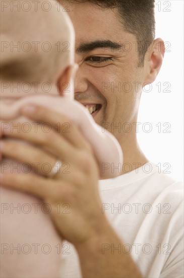 Father holding baby.