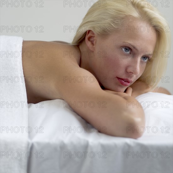 Young woman on a masseuse table.