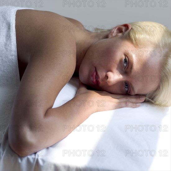 Young woman on a masseuse table.