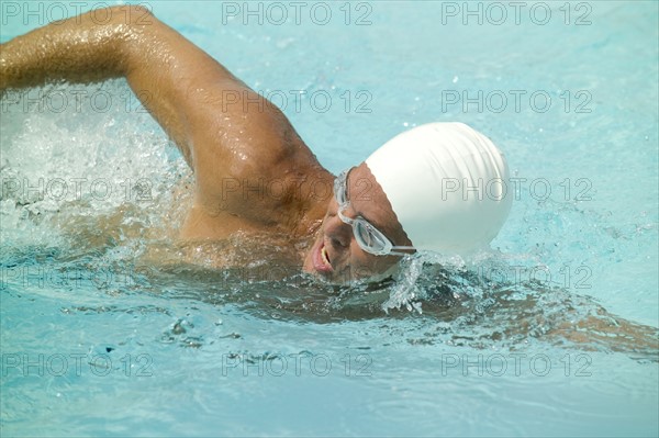 A man swimming in a pool.