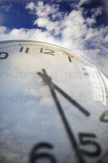 Close up of clock face and sky.