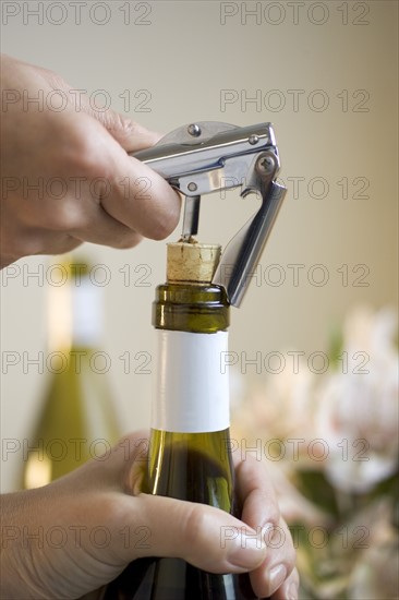 Opening a bottle of wine.