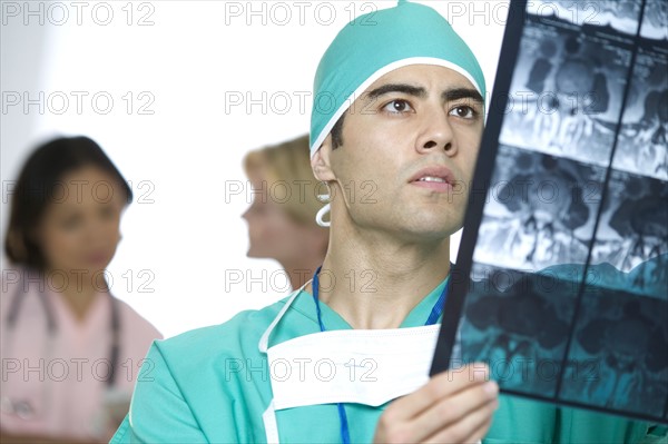 Doctor inspecting X-rays.