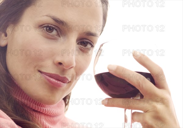 Woman holding a glass of red wine.