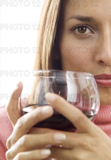 Woman holding a glass of red wine.