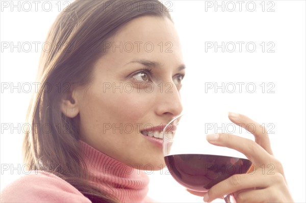 Woman holding a glass of red wine.