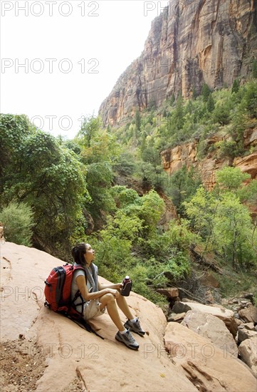 Female hiker resting on a rock.