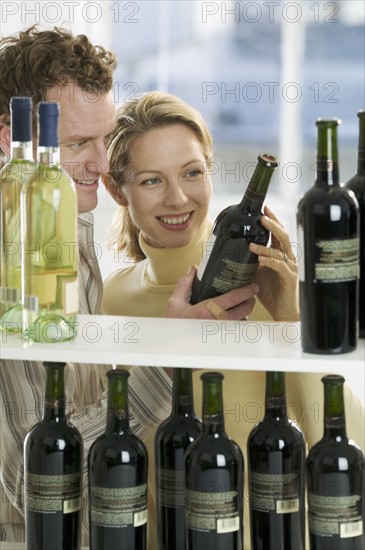 Couple selecting wine.