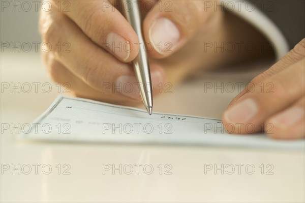 Man writing out a check.