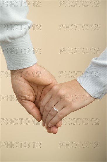 Husband and wife holding hands.