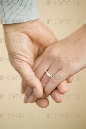 Husband and wife holding hands.