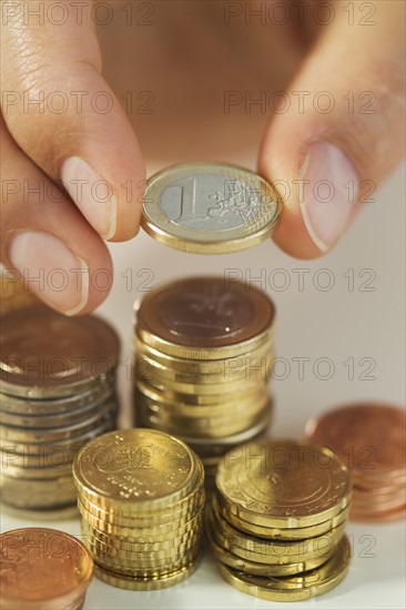 Man stacking Euro coins.