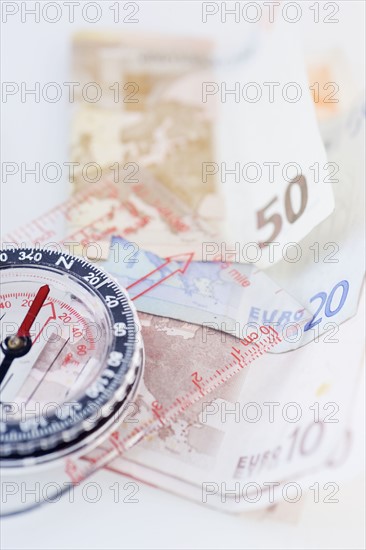 Compass with money - high angle.