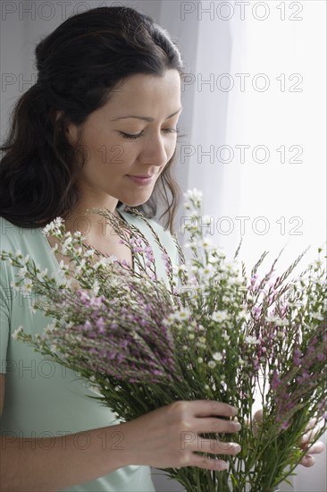 Woman arranging a bouquet of flowers.