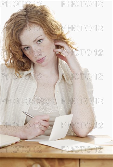 Woman writing at desk.