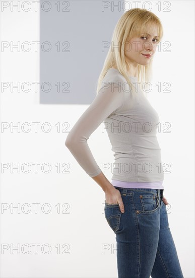 Woman with hand in back pocket.