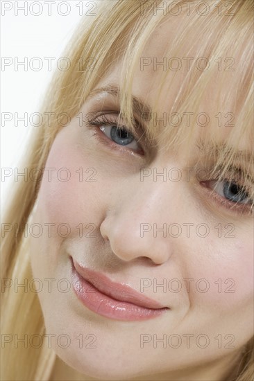 Closeup of woman gently smiling.