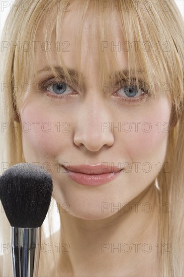 Woman with powder brush.