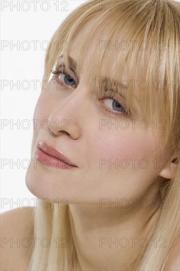 Blond woman with head tilted.