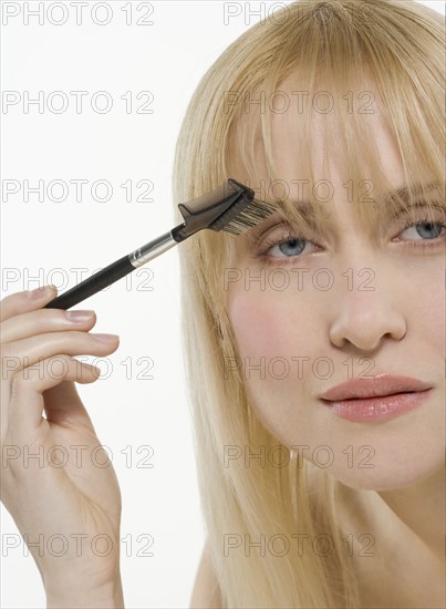 Woman using cosmetic brush.