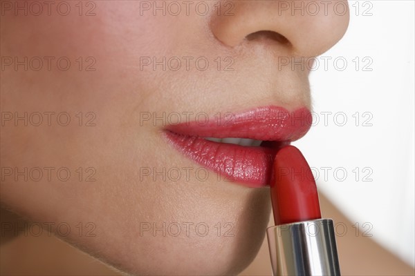 Closeup of mouth with red lipstick.