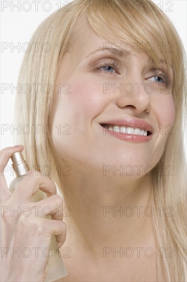 Smiling woman with spray bottle.