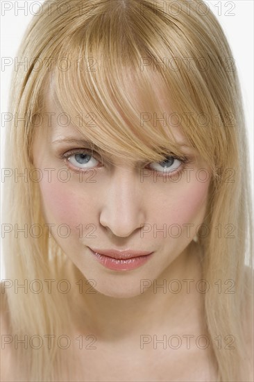 Blond woman looking up intensely.