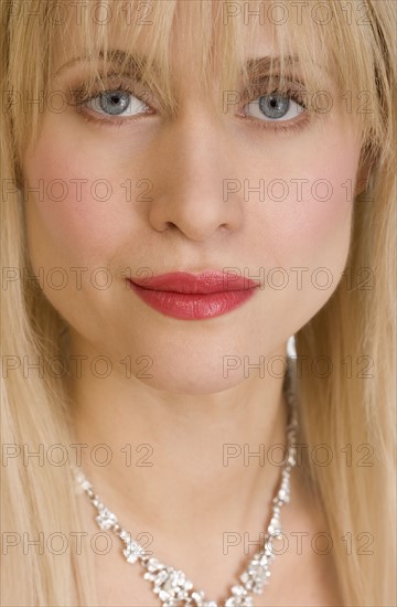 Closeup of woman wearing necklace.